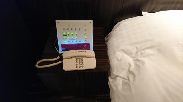 アラウダリゾート国立(国立市/ラブホテル)の写真『310号室、ベッド横の照明コントローラーと電話』by おむすび