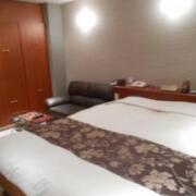 HOTEL Lmine(武雄市/ラブホテル)の写真『302号室のベッド側から、奥にソファ、備え付けの棚、冷蔵庫、備品が納められている。』by 猫饅頭